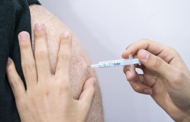 A booster coronavirus vaccine is administered