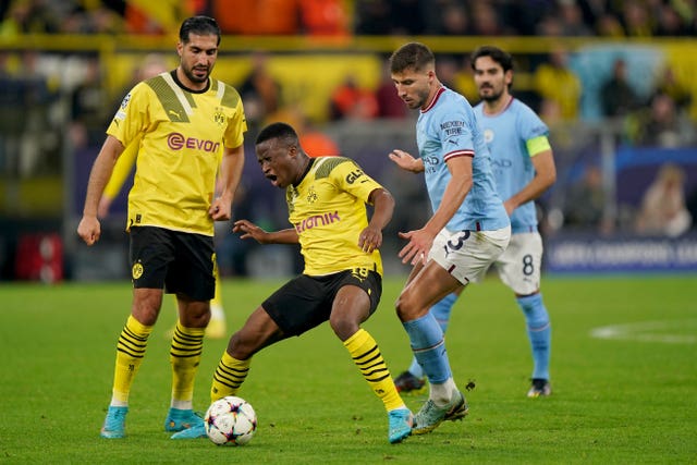 Borussia Dortmund's Youssoufa Moukoko (centre) and Manchester City's Ruben Dias in action during the UEFA Champions League group G match at Signal Iduna Park in Dortmund, Germany
