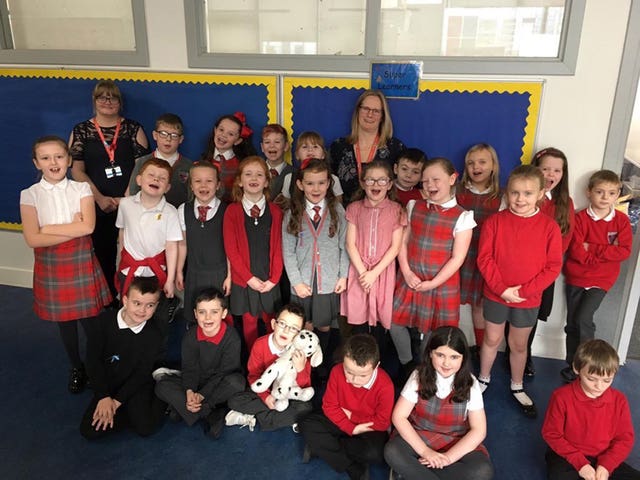 Kate McLaughlan (back row right) with her pupils at the school in Port Glasgow. The teacher has asked her pupils not to buy her any Christmas presents this year, but to help her donate to a local foodbank instead.