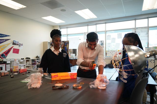 Prime Minister Rishi Sunak takes part in a science experiment as he visits the Friendship Technology Preparatory High School during his visit to Washington DC in the US