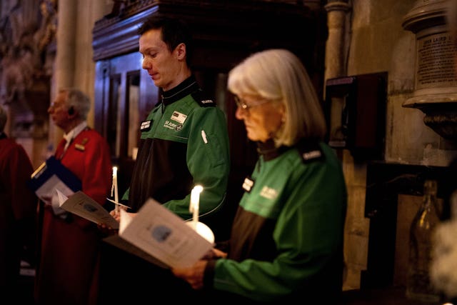 Two St John Ambulance staff holding candles 