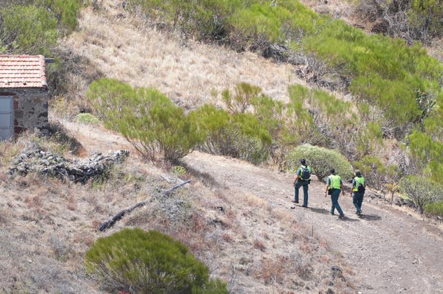 Members of a search and rescue team on a road near the last known location of Jay Slater 