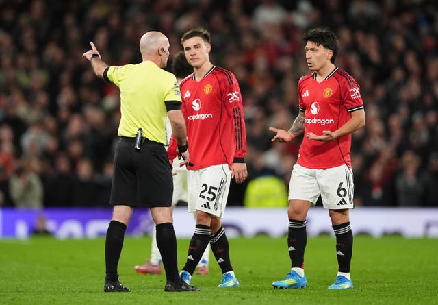 Referee Paul Tierney sends off Manchester United’s Lisandro Martinez (right)
