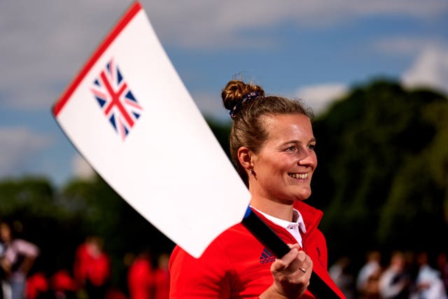Emily Ford holds aloft a paddle with the Union Flag on it. 
