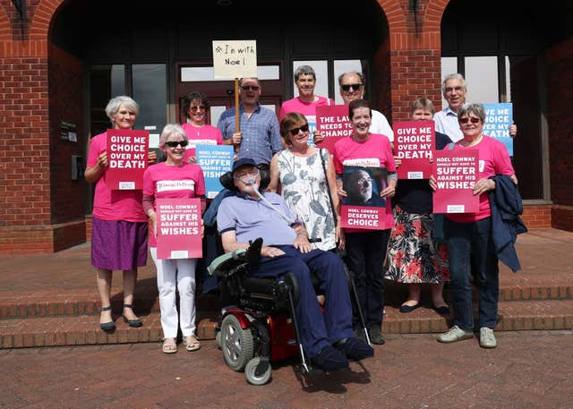 Terminally-ill Noel Conway, 68, arriving at Telford County Court with supporters to view a video link of his High Court case on assisted dying (PA/Aaron Chown)