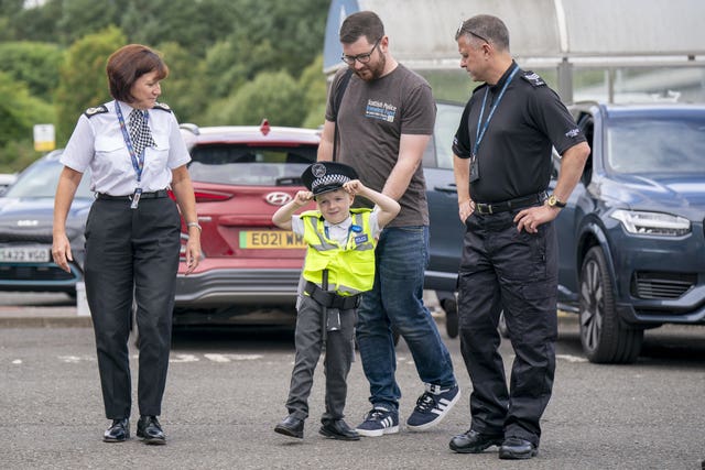 Anthony Green, six, with two men and a woman police chief