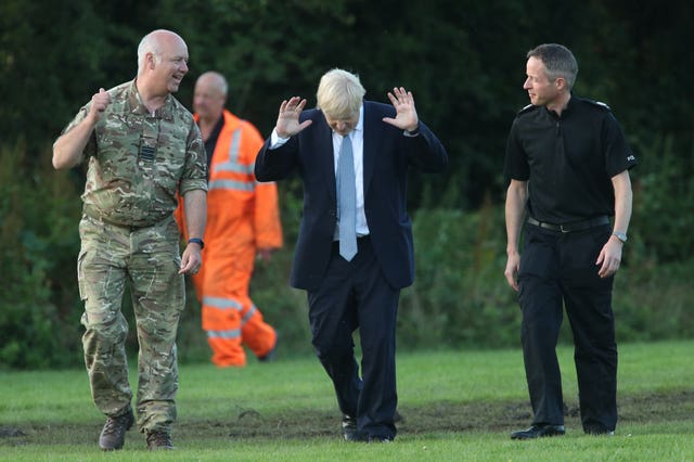 Mr Johnson arrives to meet emergency crews during a visit to Whaley Bridge Football Club (Yui Mok/PA)