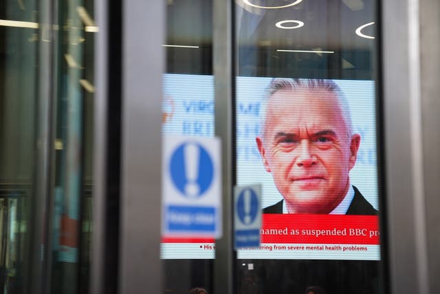 Screen showing Huw Edwards headline from inside BBC studios