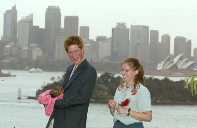 Prince Harry holds a ring-tailed possum with help from zookeeper Megan during a photocall at Taronga Zoo in Sydney to mark the start of his gap year