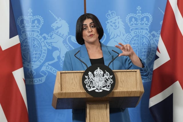 Shabana Mahmood gesturing as she speaks from behind a lectern flanked by Union flags