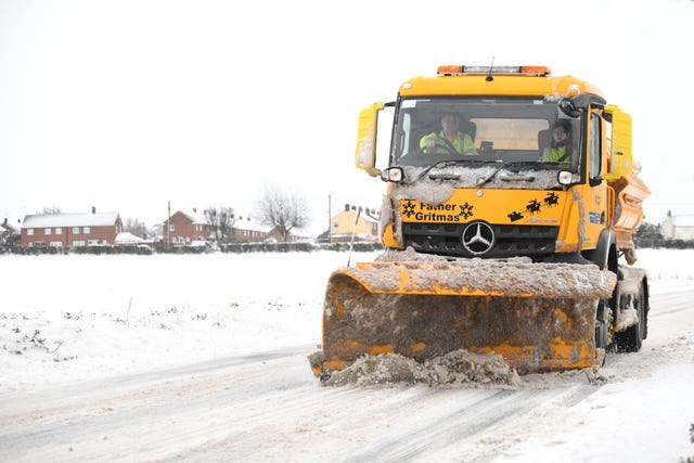 A snowplough clears the road through Barham, near Ipswich