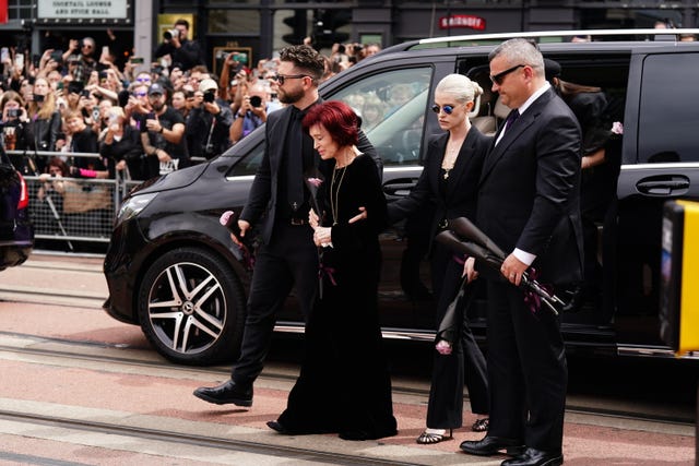 Jack, Sharon and Kelly Osbourne laying flowers and viewing the messages and floral tributes left at the Black Sabbath Bridge in Birmingham in memory of Ozzy Osbourne