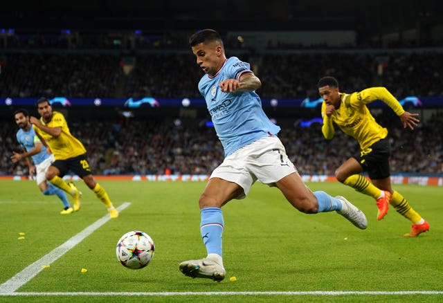Manchester City’s Joao Cancelo (centre) in action during the UEFA Champions League Group G match at the Etihad Stadium, Manchester