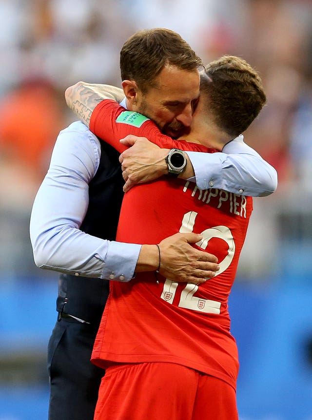 Trippier embraces Southgate after England beat Sweden on Saturday.