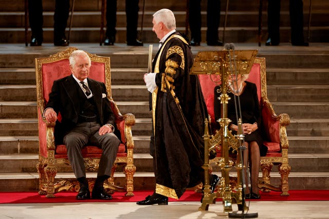 Speaker of the House of Commons Sir Lindsay Hoyle walks past King Charles and Queen Consort at Westminster Hall, London, where both Houses of Parliament are meeting to express their condolences following the death of Queen Elizabeth II