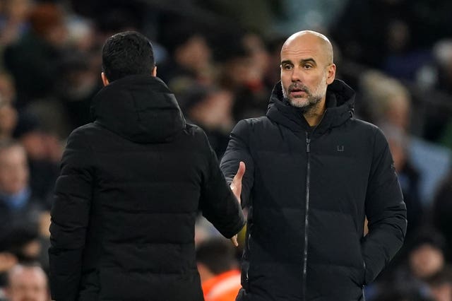 Pep Guardiola, right, is in a title battle with Arsenal counterpart Mikel Arteta 