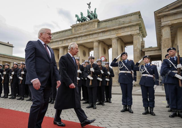 German President Frank-Walter Steinmeier (left) and the King inspect a guard of honour during the ceremonial welcome at Brandenburg Gate, Berlin 