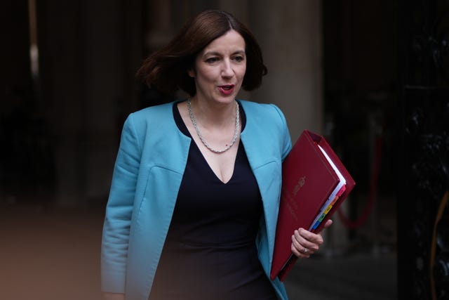 Education Secretary Bridget Phillipson in blue jacket holding red folder