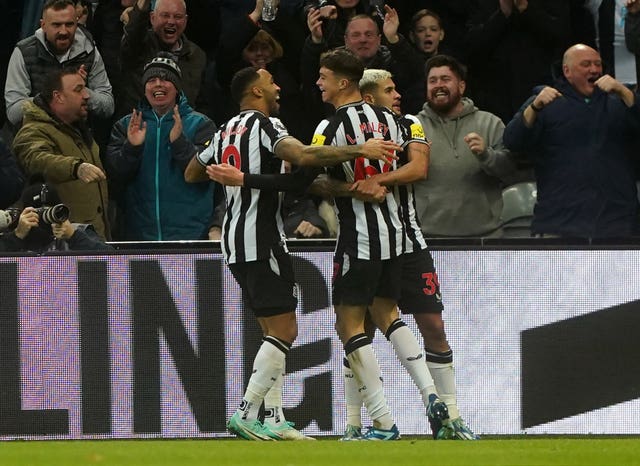 Newcastle’s Lewis Miley, centre, celebrates his first senior goal for the club