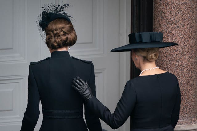 The Duchess of Edinburgh places her hand on the Princess of Wales's back as they leave the balcony at the Foreign, Commonwealth and Development Office on Remembrance Sunday