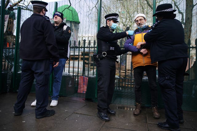 Police officers detain a man (Aaron Chown/PA)