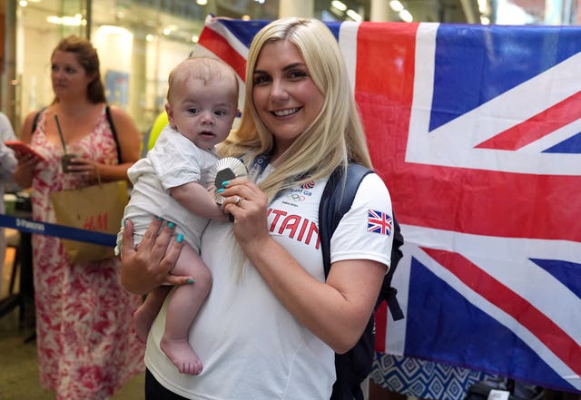 Amber Rutter holds her son Tommy and her silver medal