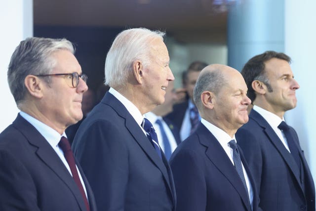 Four men in dark suits