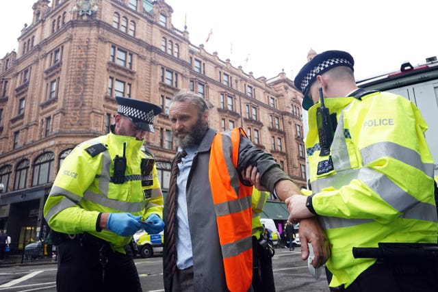 Police officers deal with activists from Just Stop Oil