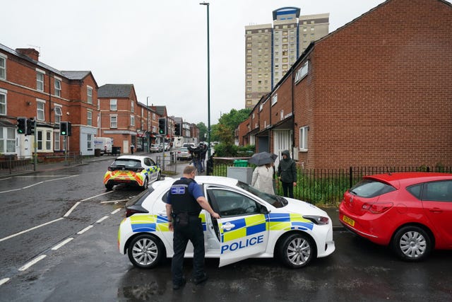 Police at the scene a day after the bodies were found