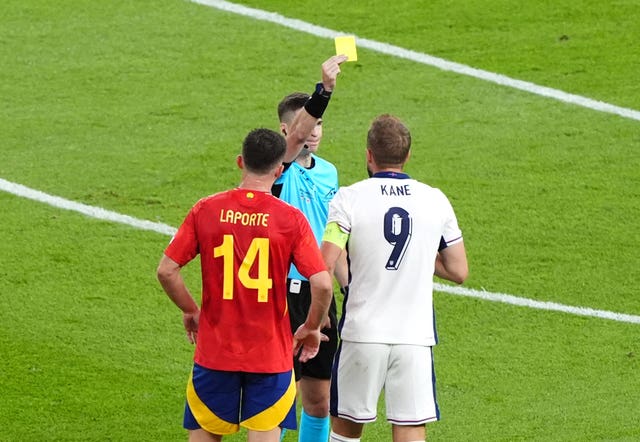 Referee Francois Letexier shows a yellow card to England’s Harry Kane 