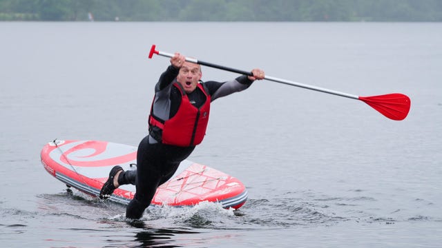 Sir Ed Davey falls into the water while paddleboarding on Lake Windermere