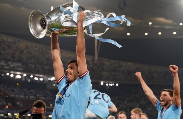 Manchester City’s Rodri celebrates with the Champions League trophy 