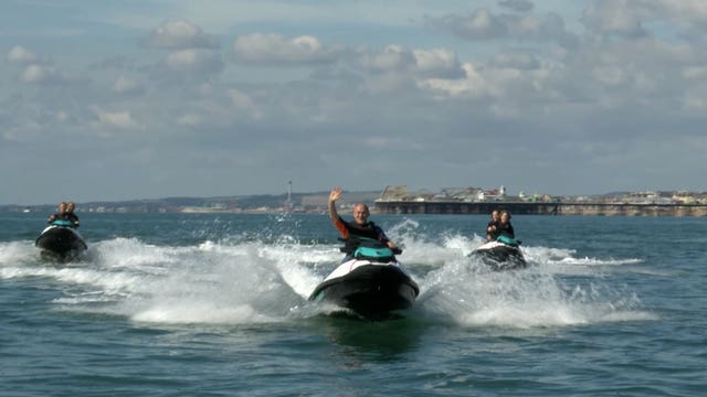 Liberal Democrat leader Sir Ed Davey jet skis into his party's conference in Brighton on Saturday