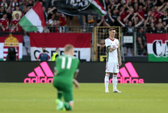 Hungary's Bendeguz Bolla stands while Republic of Ireland midfielder James McClean takes a knee at the Szusza Ferenc Stadium in Budapest