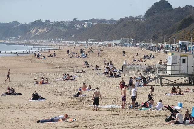 People enjoy the warm weather on Bournemouth beach