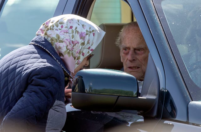 The duke, pictured speaking to the Queen, likes to drive himself around when at Sandringham or Windsor Castle. Steve Parsons/PA Wire
