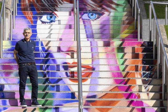 Sadiq Khan next to outdoor steps painted with a colourful mural of Taylor Swift