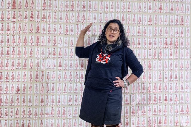 Artist Leena Nammari alongside her artwork