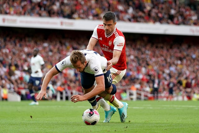 Sokratis Papastathopoulos, right, challenges Harry Kane in the penalty area