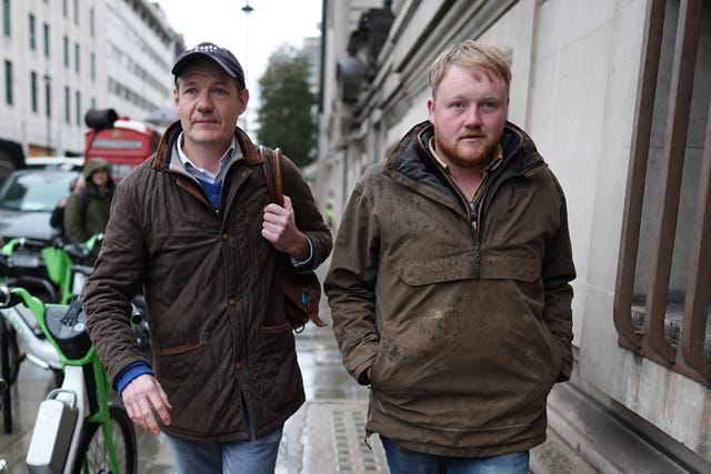 Charlie Ireland and Kaleb Cooper walking along a street 