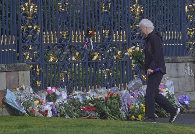 Lady Mary Elizabeth Peters lays flowers at the gates of Hillsborough Castle in County Down