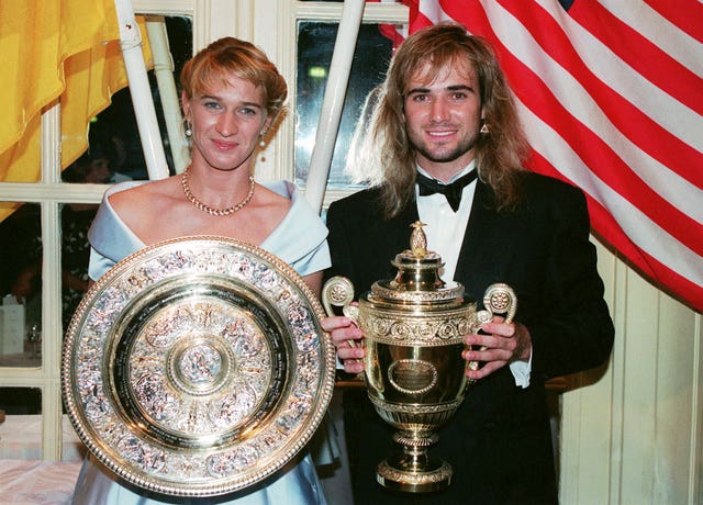 Andre Agassi and Steffi Graf with their Wimbledon trophies in 1992 (PA)