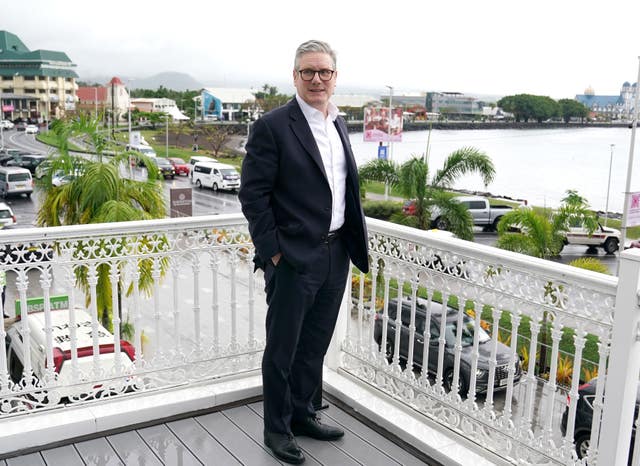 Sir Keir Starmer standing on a balcony in Apia, Samoa