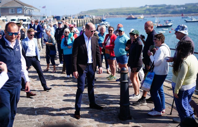 The Prince of Wales chats to people during a visit to St Mary’s Harbour, the maritime gateway to the Isles of Scilly