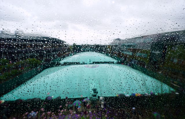 Rain falls at Wimbledon as the covers are on the courts