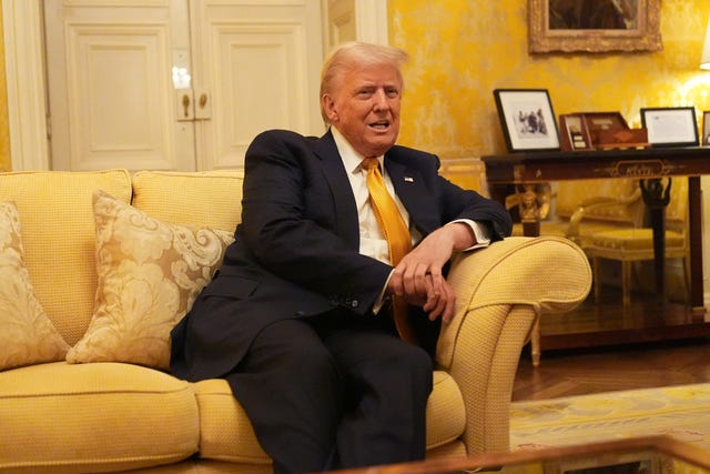 US President Donald Trump sitting on a yellow sofa