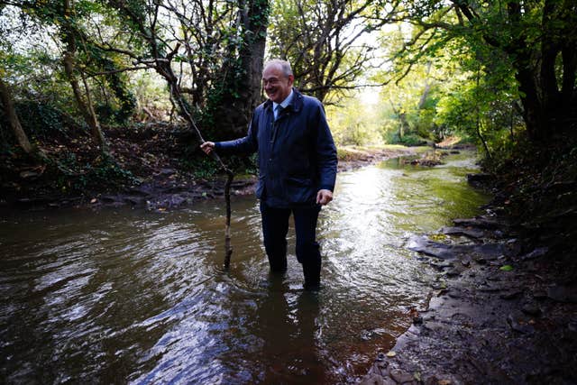 Sir Ed Davey standing in water