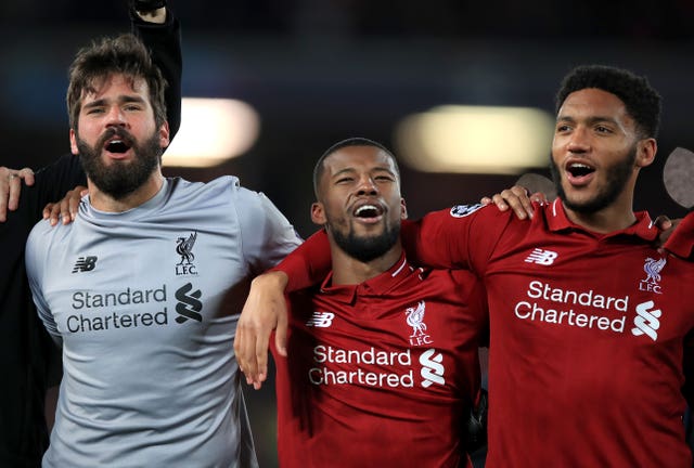 Alisson Becker, left, celebrates with team-mates after playing a major role in the win over Barcelona