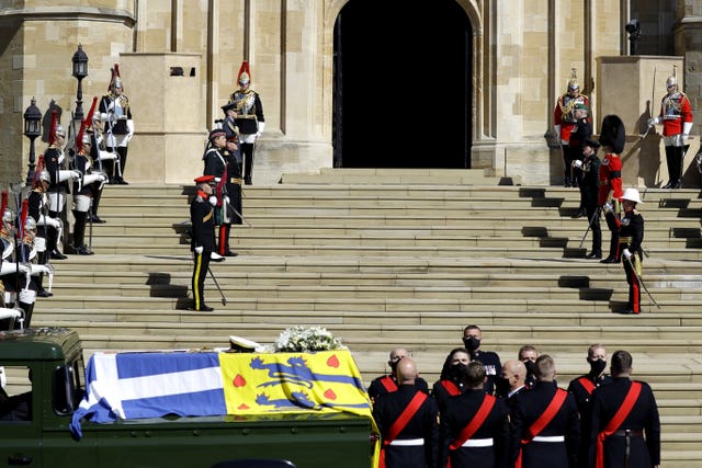 The Duke of Edinburgh’s coffin, covered with His Royal Highness’s Personal Standard, on the Land Rover Defender outside St George’s Chapel, Windsor Castle, Berkshire