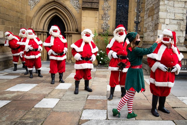 Santas at The Ministry of Fun’s Summer School have their temperature taken at Southwark Cathedral, London which aims to create COVID-safe Christmas grottos by teaching Father Christmases how to appear safely in person whilst maintaining the Christmas magic